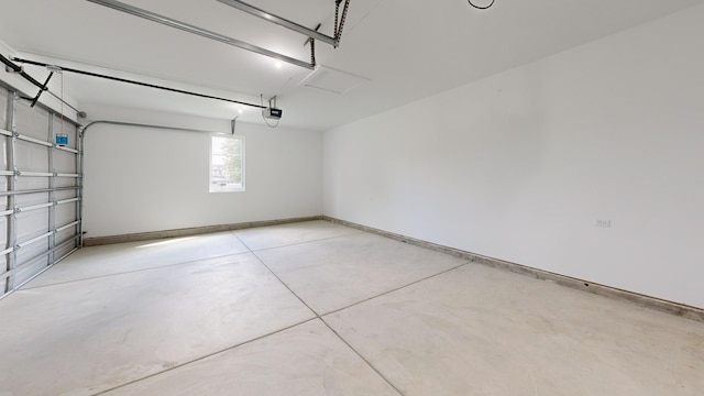 garage with a garage door opener and baseboards