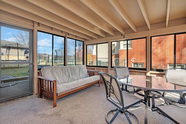 sunroom featuring beamed ceiling