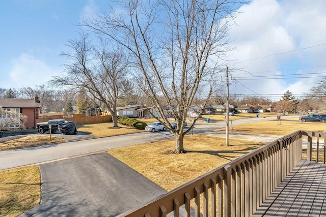 exterior space featuring a residential view and fence