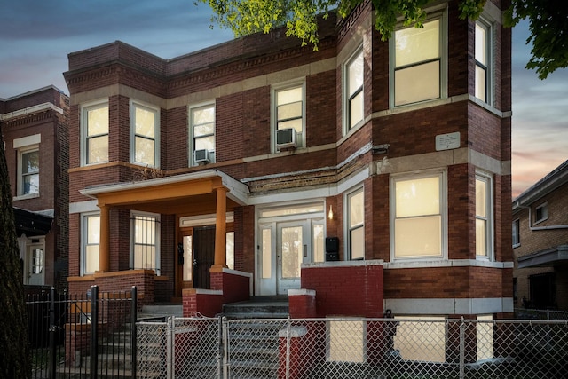 5412 S Wood St, Chicago, IL 60609 - townhome / multi-family property with a gate, cooling unit, brick siding, a fenced front yard, and a porch