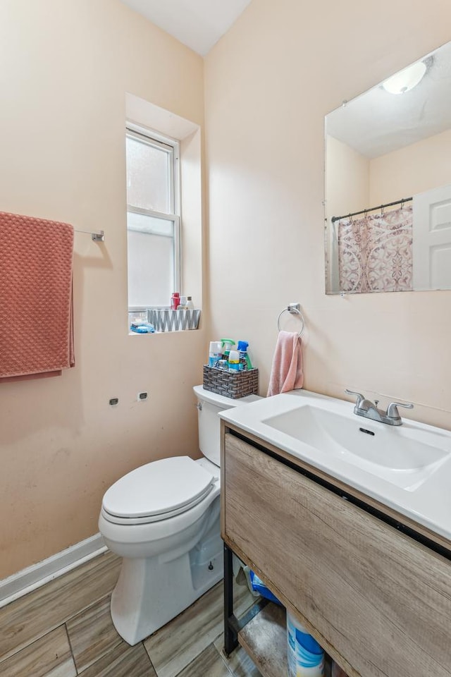 5412 S Wood St, Chicago, IL 60609 - full bath featuring baseboards, toilet, vanity, and wood finished floors