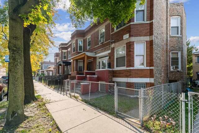 5412 S Wood St, Chicago, IL 60609 - view of front of home with brick siding, a fenced front yard, and a residential view