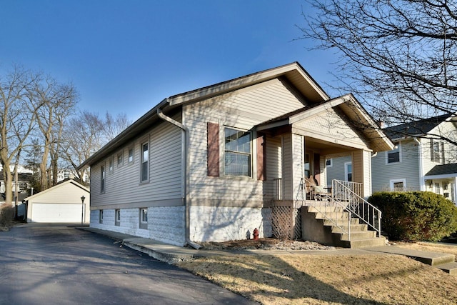 bungalow-style house featuring a garage and an outdoor structure