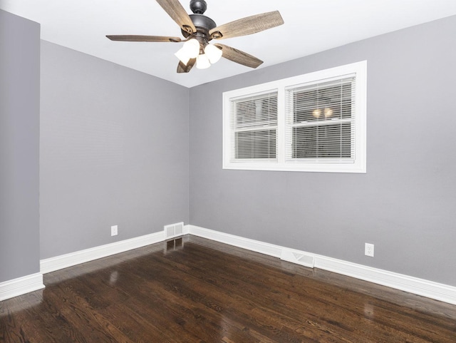 spare room with visible vents, ceiling fan, baseboards, and wood finished floors