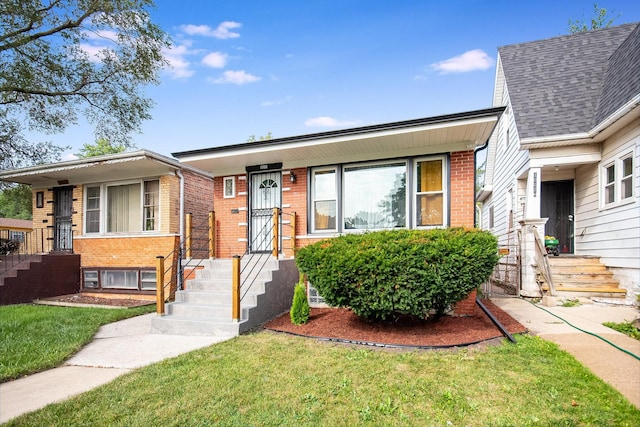 view of front of house featuring a front yard and brick siding