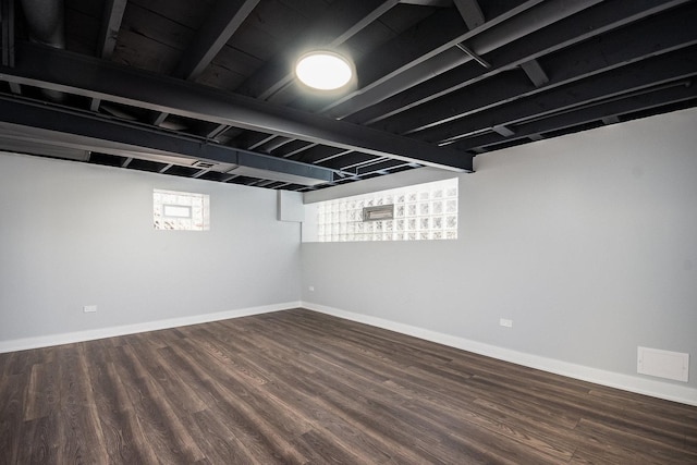 below grade area featuring baseboards and wood finished floors