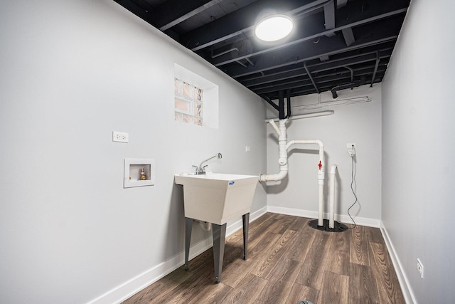 washroom with wood finished floors and baseboards