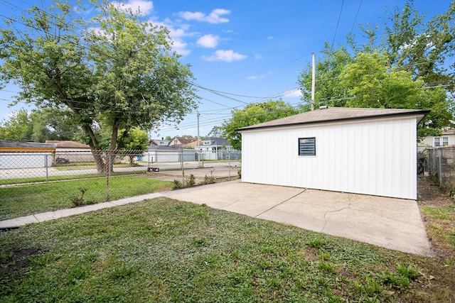 view of yard with an outbuilding, a patio, and fence