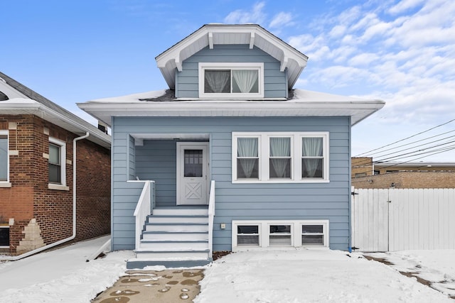 bungalow-style home featuring fence