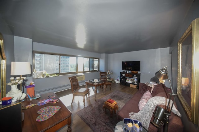 living area with baseboard heating and wood finished floors