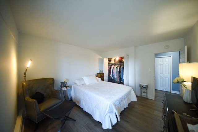 bedroom with dark wood-style floors and baseboards