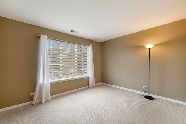 unfurnished room featuring light carpet, baseboards, and visible vents