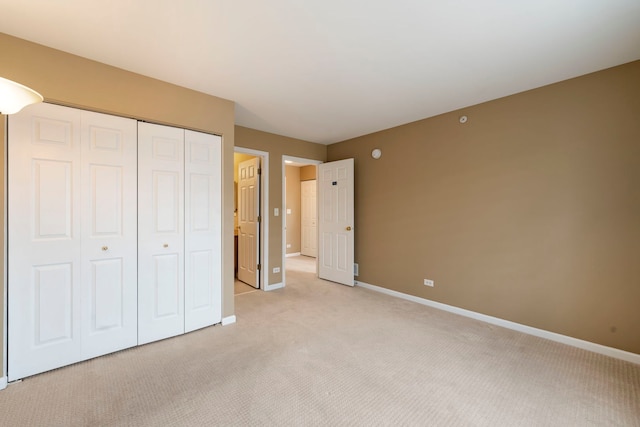 unfurnished bedroom with baseboards, a closet, and light colored carpet