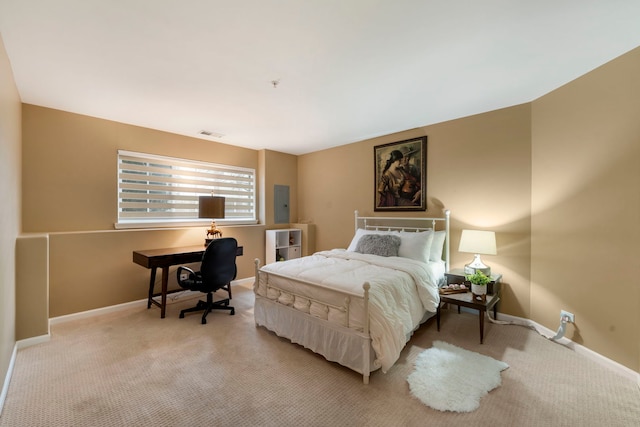 bedroom with electric panel, light carpet, visible vents, and baseboards