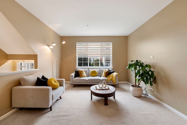 living area featuring carpet floors and baseboards