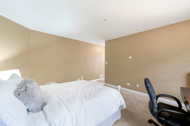 bedroom with baseboards and light colored carpet