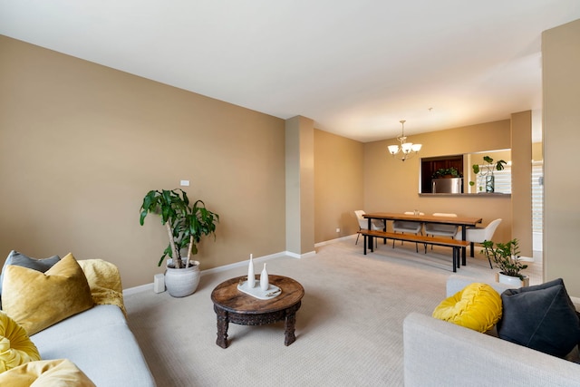 living room with a chandelier, carpet, and baseboards