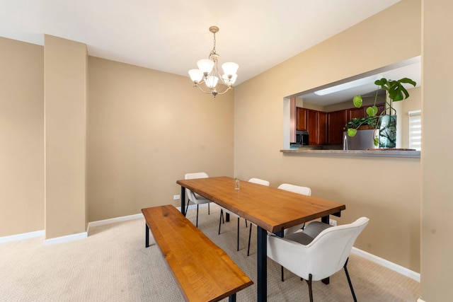 dining area with light carpet, baseboards, and a notable chandelier