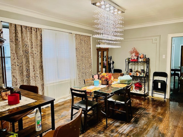 dining space with a chandelier, wood-type flooring, and crown molding