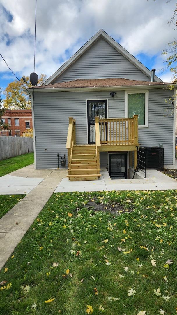 back of property featuring a patio area, a yard, a deck, and fence