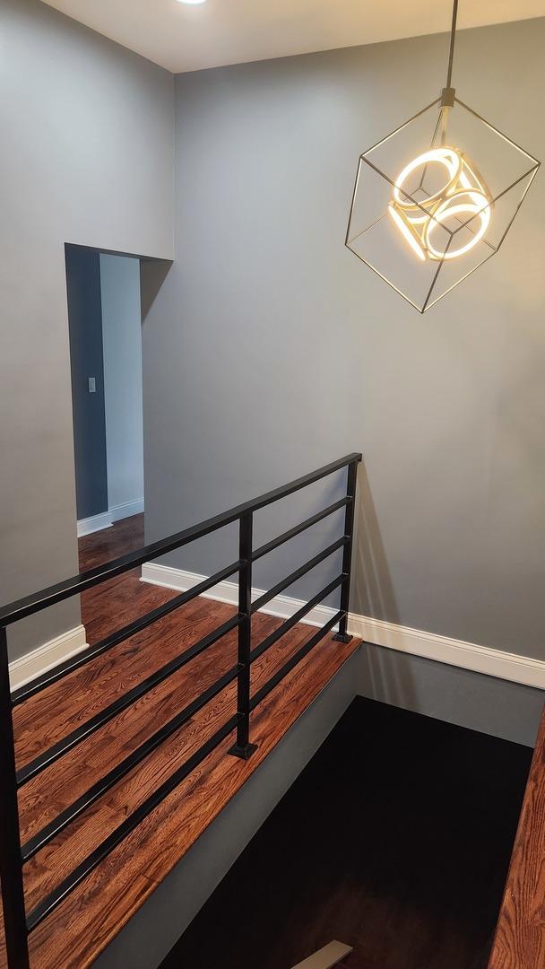 stairs featuring baseboards and wood finished floors