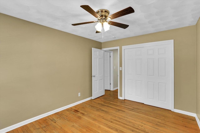 604 Park Lane Dr, Champaign, IL 61820 - unfurnished bedroom with baseboards, light wood-type flooring, a closet, and ceiling fan