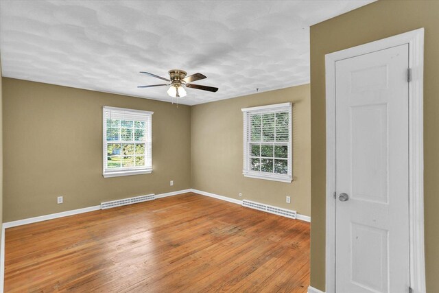 604 Park Lane Dr, Champaign, IL 61820 - spare room featuring a ceiling fan, light wood-style flooring, baseboards, and a baseboard radiator