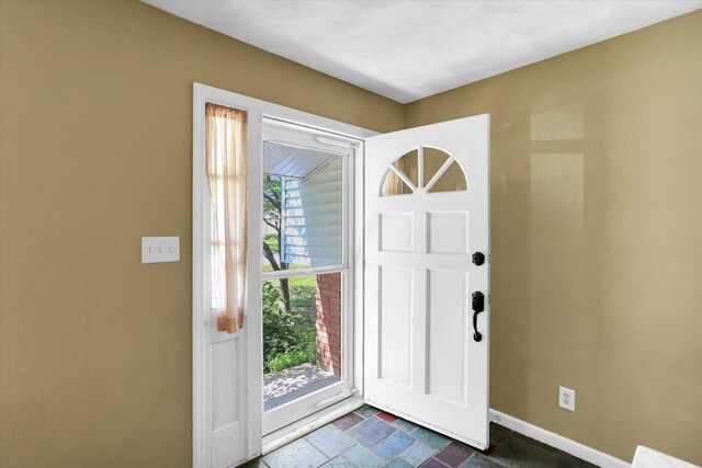 604 Park Lane Dr, Champaign, IL 61820 - entryway featuring baseboards and dark stone finish flooring