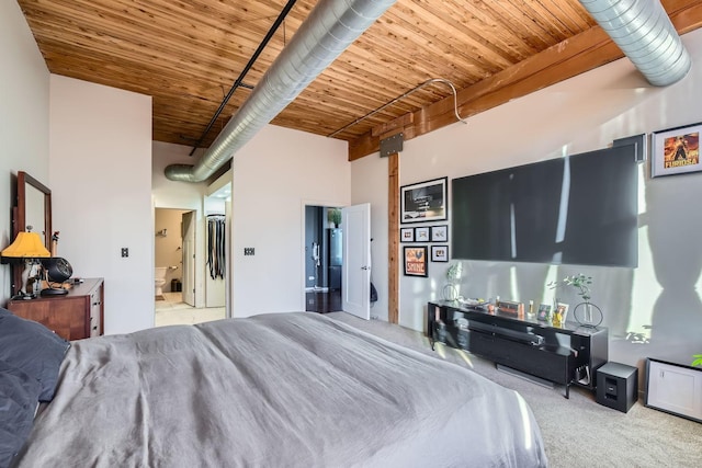 carpeted bedroom featuring a high ceiling, wooden ceiling, and connected bathroom