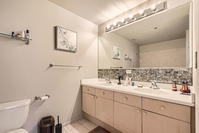 full bathroom with decorative backsplash, a sink, toilet, and tile patterned floors