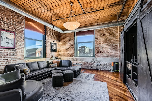 living area with brick wall, wood finished floors, and wood ceiling