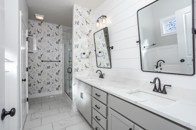 bathroom with marble finish floor, double vanity, a sink, and a shower stall