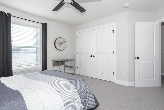 bedroom with ceiling fan, carpet floors, a closet, and baseboards