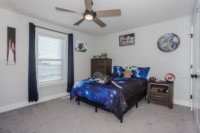 carpeted bedroom featuring ceiling fan and baseboards