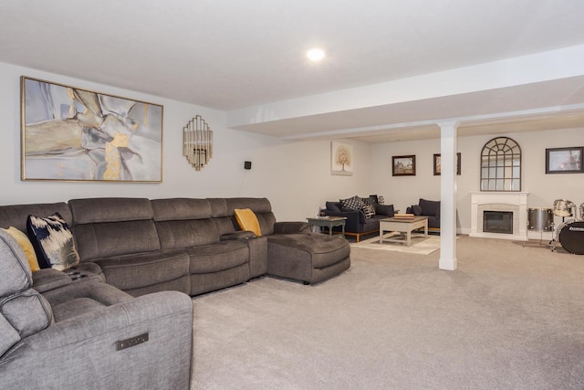 living area featuring light carpet and a glass covered fireplace