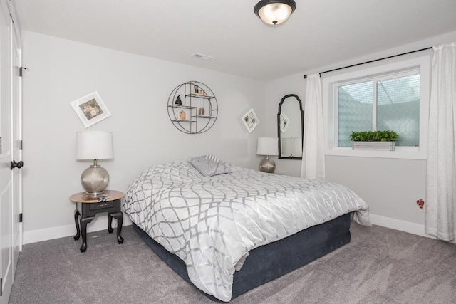 bedroom with carpet, visible vents, and baseboards