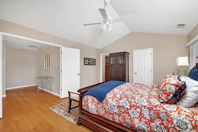 bedroom with lofted ceiling, baseboards, visible vents, and light wood-style floors