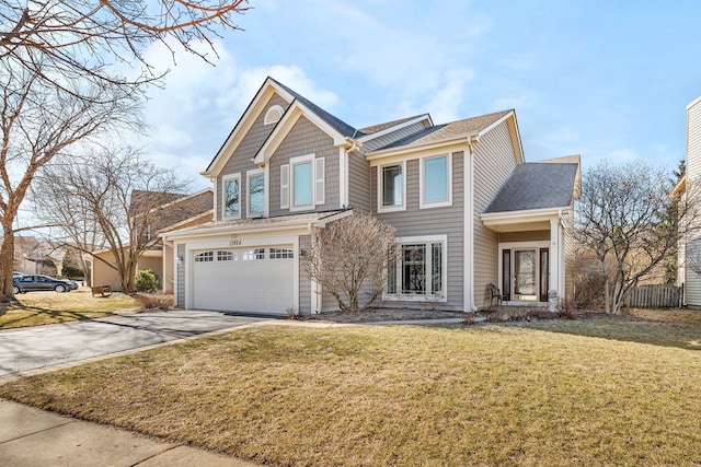 view of front of home featuring a garage, driveway, and a front lawn