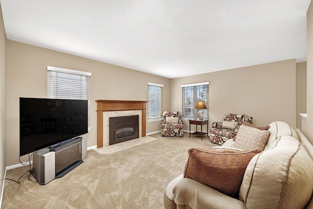 living room featuring carpet, a fireplace with flush hearth, a wealth of natural light, and baseboards