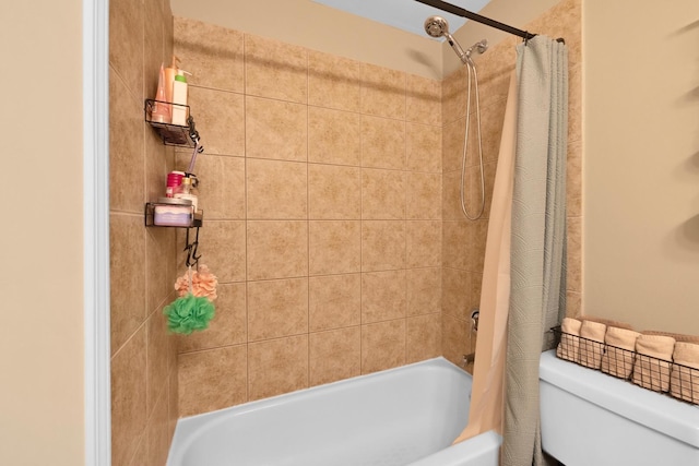 bathroom with shower / bath combo with shower curtain and toilet