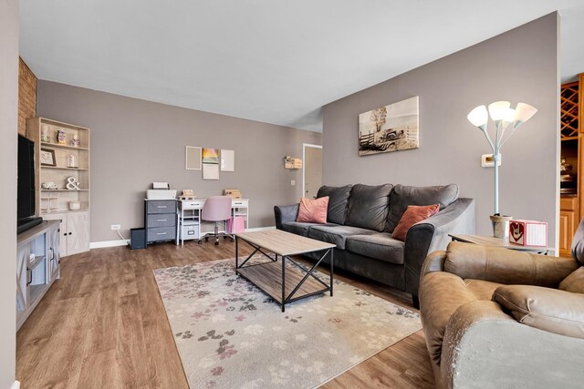 living area featuring wood finished floors and baseboards