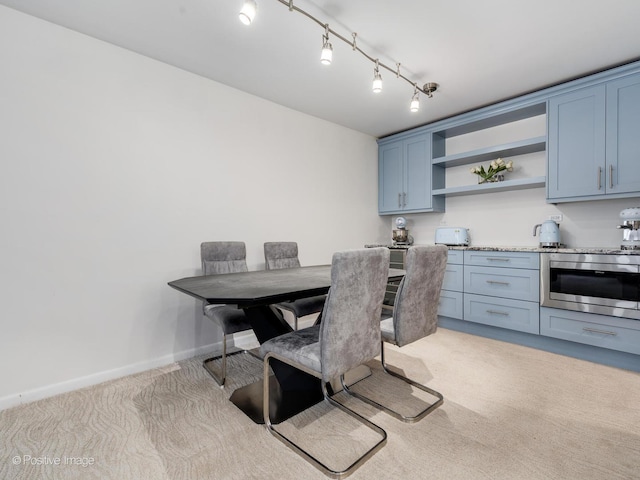 155 N Harbor Dr Unit 4505, Chicago, IL 60601 - dining area featuring baseboards, rail lighting, and light colored carpet