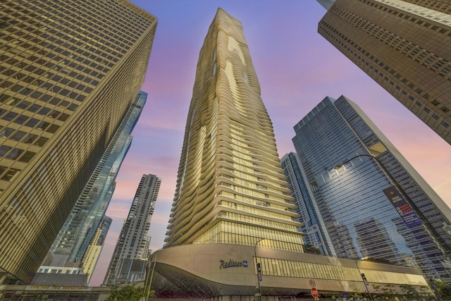 property at dusk featuring a view of city