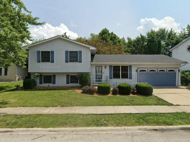 split level home featuring an attached garage, driveway, and a front yard