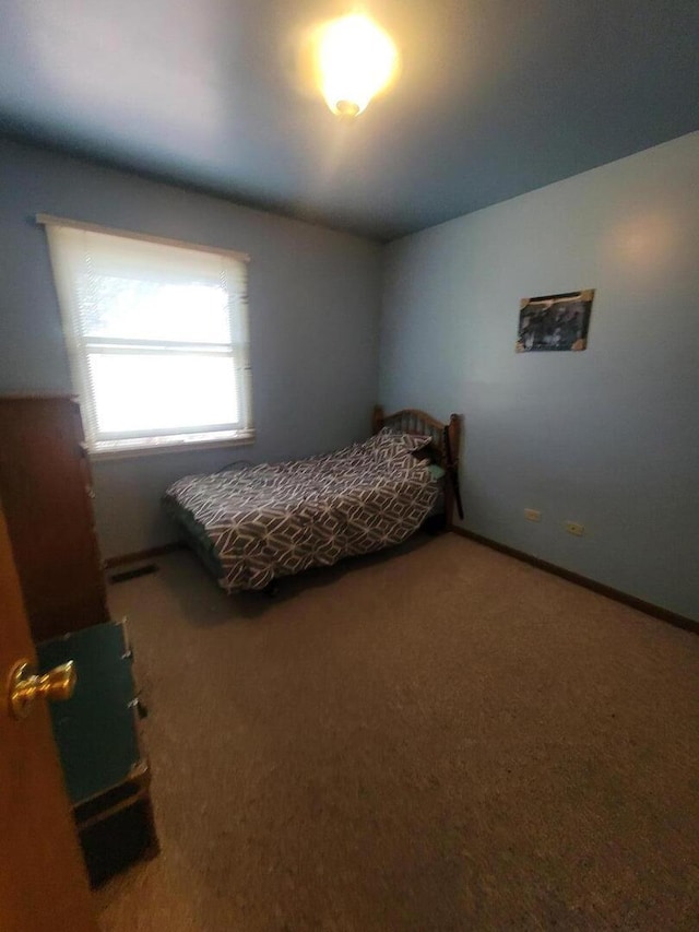 carpeted bedroom featuring baseboards