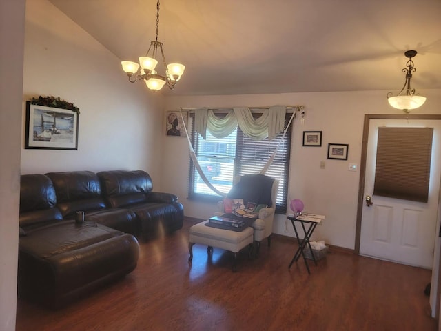 living room featuring an inviting chandelier, vaulted ceiling, baseboards, and wood finished floors