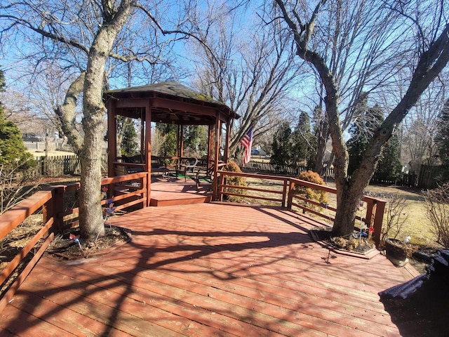 wooden deck featuring a gazebo and fence