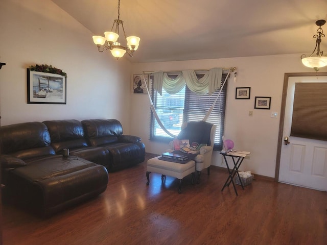 living area with baseboards, wood finished floors, lofted ceiling, and a notable chandelier