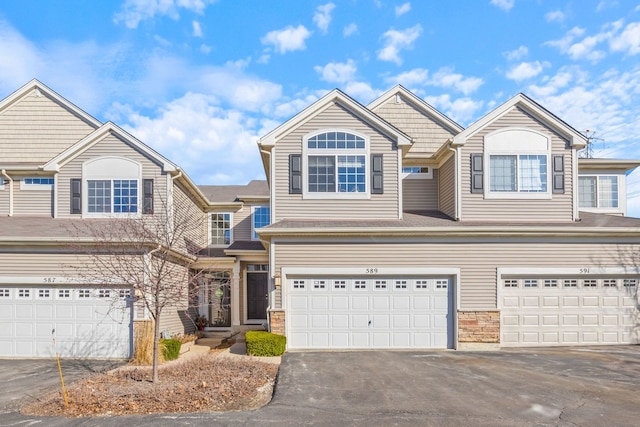 view of front of property featuring aphalt driveway and an attached garage