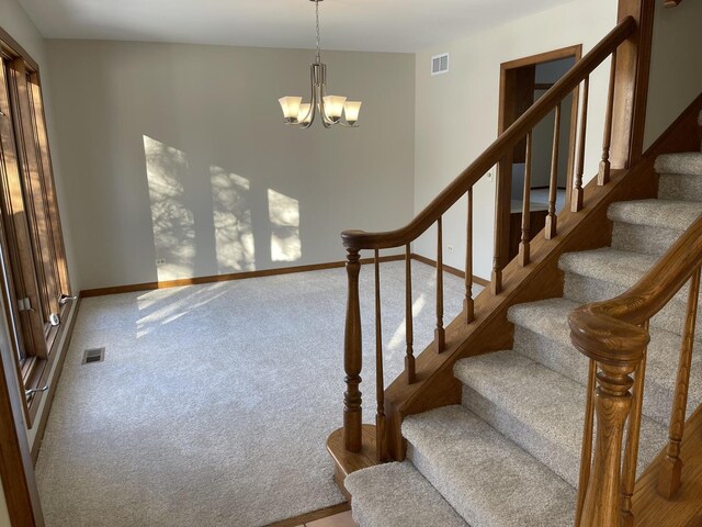 stairs featuring carpet, visible vents, baseboards, and an inviting chandelier